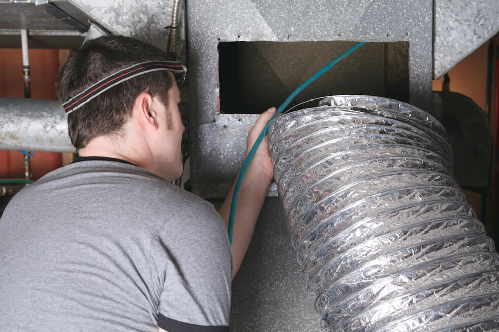 hvac technician checking air ducts