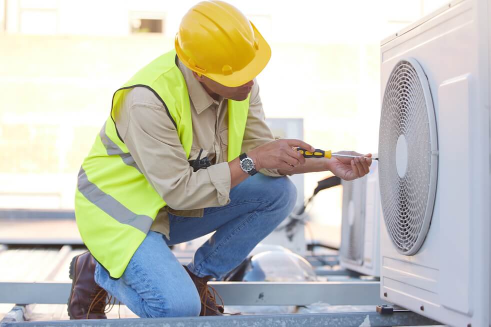 hvac technician checking ac unit