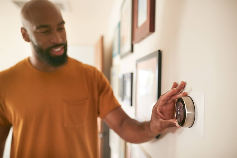 man checking thermostat