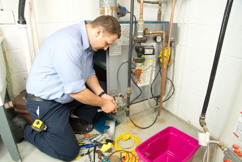 hvac technician fixing furnace